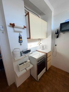 a small kitchen with a stove and a sink at Marachique Beach Flat in Alvor
