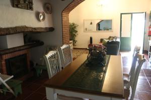 a living room with a table and a fireplace at C M Casa de Mares Alojamento Local in Casas Novas de Marés +4 photos