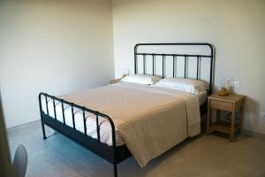 a bedroom with a bed and a side table at Masseria Marchesani in Montenero di Bisaccia