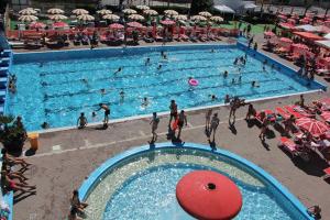 a group of people in a swimming pool at Appartamenti Desi Riccione in Riccione