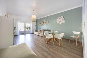 a living room with a table and a couch at T1 Morderno - Alvor in Alvor