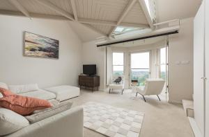 a living room with a couch and a tv at West End Townhouse in Edinburgh