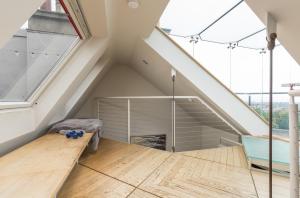 an attic bedroom with a bed and a window at West End Townhouse in Edinburgh