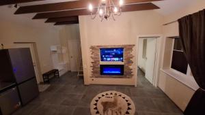 a living room with a fireplace and a tv at Edelweiss Vila Šventoji in Šventoji
