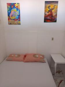 a bed in a room with two paintings on the wall at Mina in Krašići