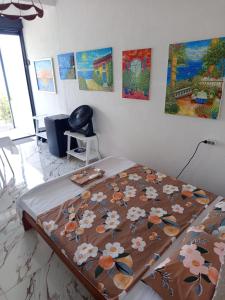 a bed in a room with paintings on the wall at Mina in Krašići