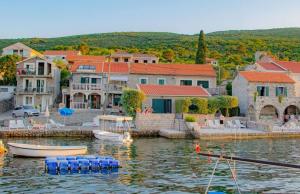 a group of houses and boats in a body of water at Mina in Krašići