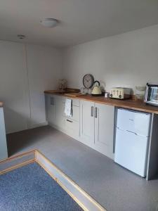 a kitchen with white cabinets and a counter top at Beautiful 1-Bed Apartment in Sandy in Sandy