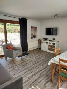 a living room with a couch and a tv and a table at Beautiful 1-Bed Apartment in Sandy in Sandy