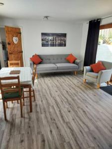 a living room with a couch and a table and chairs at Beautiful 1-Bed Apartment in Sandy in Sandy