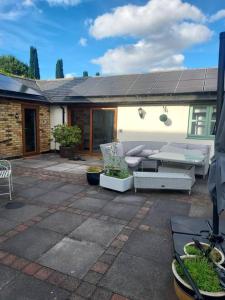 a patio with couches and chairs on a house at Beautiful 1-Bed Apartment in Sandy in Sandy