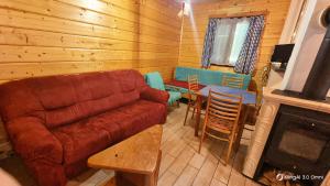 a living room with a couch and a table at Chata U malého Janka in Bojnice