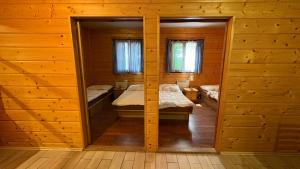 a room with two beds in a log cabin at Chata U malého Janka in Bojnice