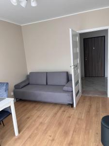 a living room with a couch and a door at Royal Apartment in Rumia