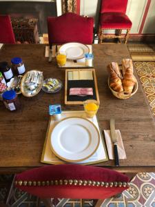 a table with plates of food and bread on it at Mansio VitAE in Nolay +16 photos