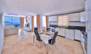 a kitchen and dining room with a table and chairs at Apollon Apartment in Kalkan