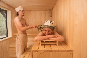 a man and a woman in a sauna at "The Nest" Premium Mountain Lodge with Alpine retreat & Sauna in Vanadzor