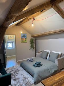 a bedroom with a large bed with two towels on it at Belgica-Melay 52400 in Melay