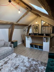a living room with a couch and a table at Belgica-Melay 52400 in Melay