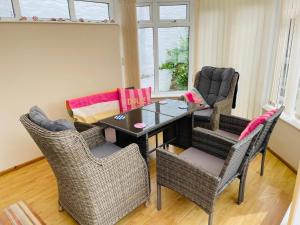 a dining room with a table and chairs at The Coach House in Braunton