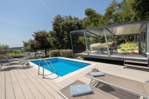 a swimming pool on a deck with a pavilion at Porton Nature Hideouts in Rovinj