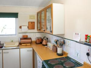 a kitchen with a stove and a counter top at Noddfa in Newcastle Emlyn