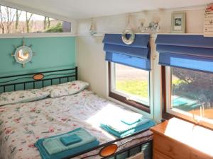 a bedroom with a bed and a window at Noddfa in Newcastle Emlyn