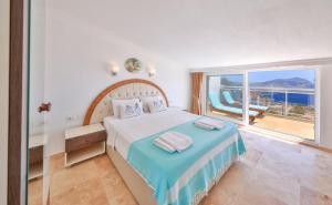 a bedroom with a bed with a view of the ocean at Apollon Apartment in Kalkan +31 photos