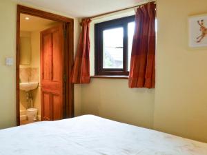 a bedroom with a bed and a window at Fennel in Kelly