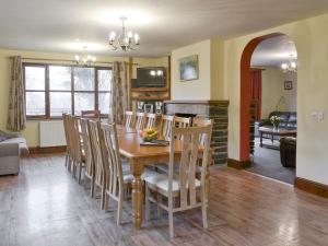 a dining room and living room with a table and chairs at Elderberry House in Kelly