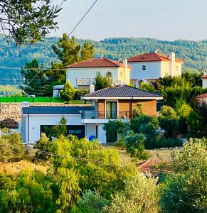 a house on a hill with trees at Villa Ada Bohème in Muğla