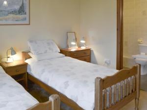 a bedroom with two beds and two night stands at Elderberry House in Kelly +17 photos