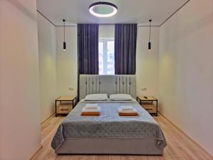 a bedroom with a bed with two pillows on it at Villa Nikoletta SPA in Bukovel