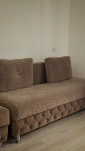 a brown couch sitting in a room at Villa Nikoletta SPA in Bukovel +112 photos