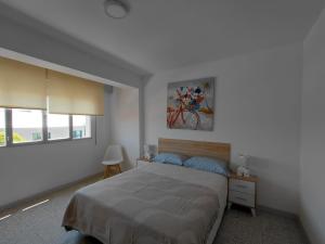a bedroom with a bed and a painting on the wall at Pedra Pateira 1 in Ribeira +9 photos