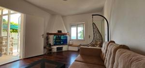 a living room with a couch and a fireplace at Apartmani MAS in Dobra Voda