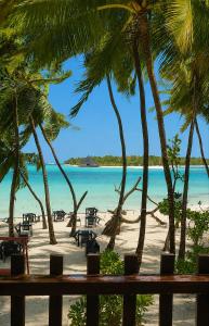 a view of a beach with palm trees and the ocean at Portia Hotel & Spa - Beachfront in Dhiffushi