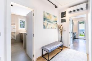 a home office with a bench in a hallway at LUX Dolce Vista Apartment - Portorož in Portorož