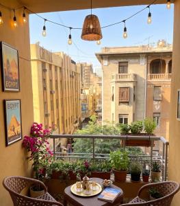 a balcony with a table and chairs and a view of a city at Parque Praca hotel in Cairo