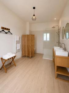 a large bathroom with a sink and a mirror at Le Domaine de La Tour des Vents in Bergerac +42 photos