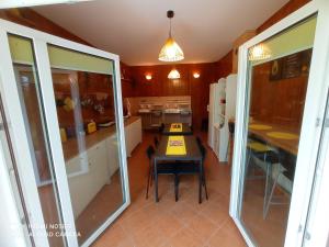 a kitchen with a table and a dining room at Biały Dom - Pokoje in Wejsuny +39 photos