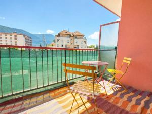 a balcony with two chairs and a table on a balcony at Urban Nest Geneva Tramway in Gaillard