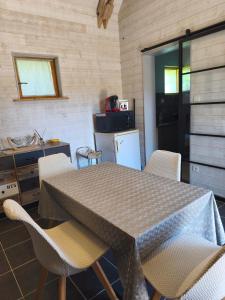 a kitchen with a table and chairs in a room at Gîte la Forterie in Linières-Bouton
