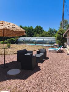 a group of chairs and an umbrella and a train at Gîte la Forterie in Linières-Bouton +2 photos