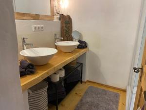 a bathroom with two sinks and a mirror on a counter at SOMMERFRISCHE TSCHENGLS Ein ganzes historisches Ferienhaus für euch in SÜDTIROL Urlaub im ruhigen Bergdorf Tschengls im Vinschgau mit Weitblick und Gartenterrasse ideal für Kleingruppen Familien mit Hund Besonders empfehlenswert im FRÜHLING und HERBST in Lasa +39 photos