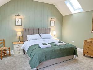 a bedroom with a large bed with towels on it at The Dairy - Uk50427 in Malton