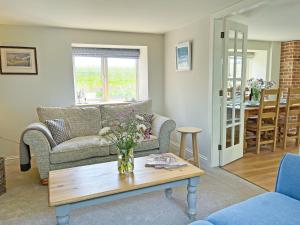 a living room with a couch and a table at The Dairy - Uk50427 in Malton