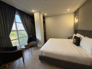 a hotel room with a bed and a large window at THREE TREE Signature Hotel-G7 Markaz Islamabad in Islamabad
