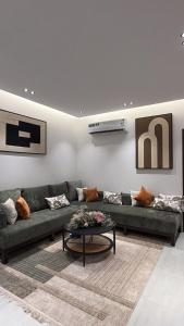 a living room with a couch and a table at Spacious Two-Bedroom Apartment with a Large Living Room, comfortable and well organized, perfect for a relaxing stay in Jeddah