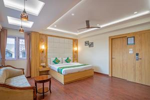 a hotel room with a bed and a couch at Treebo Sheel, Near Mall Road in Shimla +24 photos